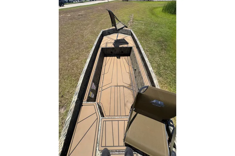 Slide: The Image of 2026 Tracker Grizzly 1650 T Prairie Wings Edition boat with camo seating and spacious deck. - 40