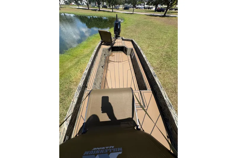 Slide: The Image of 2026 Tracker Grizzly 1650 T Prairie Wings Edition boat on grassy shore by a lake. - 41