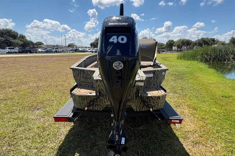 Slide: The Image of 2026 Tracker Grizzly 1650 T Prairie Wings Edition boat with Mercury 40 engine on grass. - 35