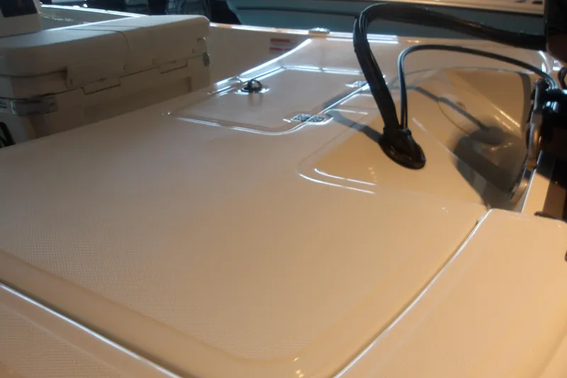 Slide: The Image of 2026 Mako Pro Skiff 17 CC boat deck with storage compartment and wiring details. - 8