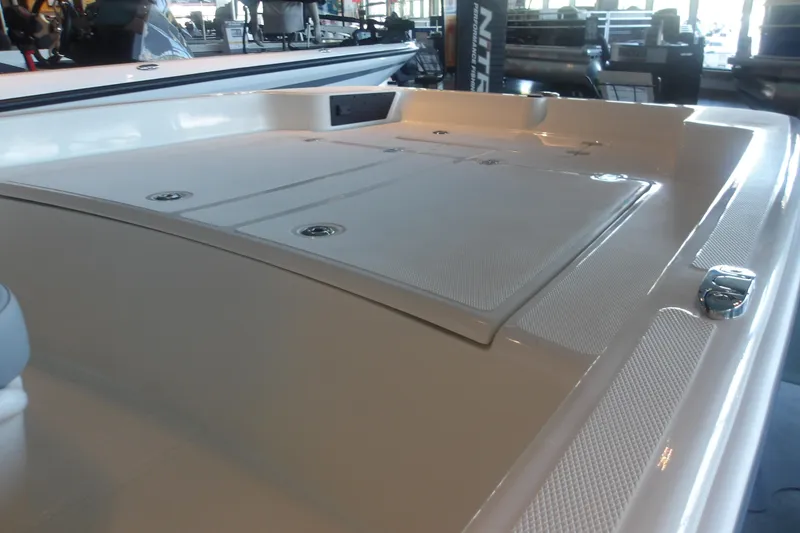 Slide: The Image of 2026 Mako Pro Skiff 17 CC boat deck in showroom lighting. - 13