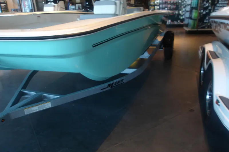 Slide: The Image of 2026 Mako Pro Skiff 17 CC boat on trailer in showroom. - 4