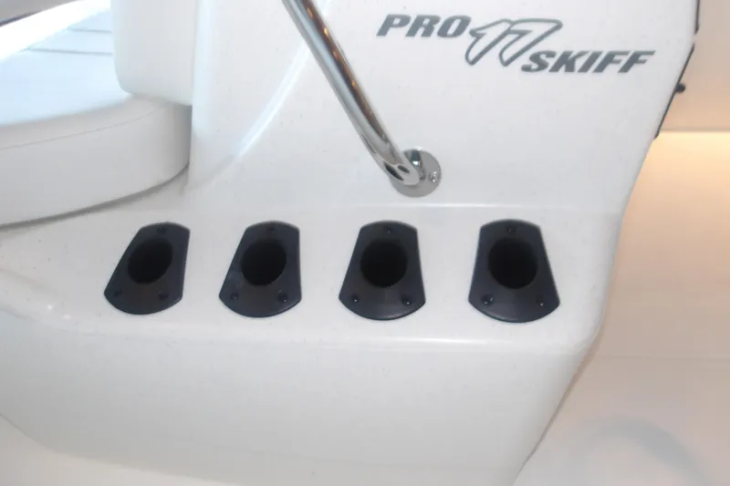 Slide: The Image of 2026 Mako Pro Skiff 17 CC boat rod holders and logo detail. - 17