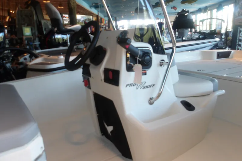 Slide: The Image of 2026 Mako Pro Skiff 17 CC boat interior with steering console and seating. - 12