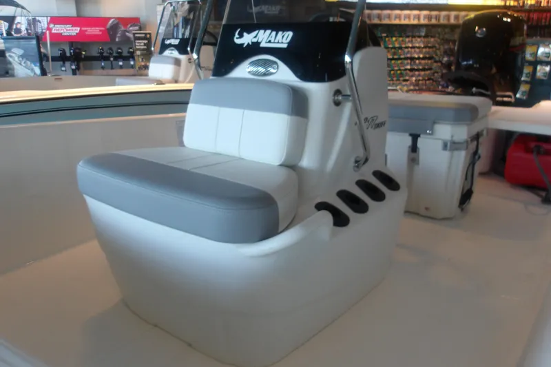 Slide: The Image of 2026 Mako Pro Skiff 17 CC boat interior with cushioned seating and storage compartments. - 5