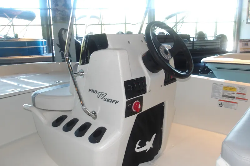 Slide: The Image of 2026 Mako Pro Skiff 17 CC boat console with steering wheel and controls. - 7