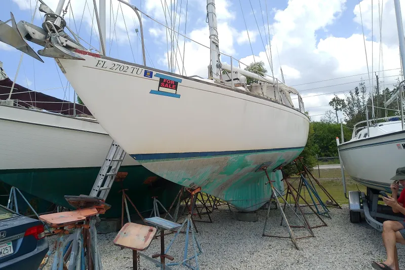 The Image of 1981 Sea Sprite 34 sailboat on stands, for sale, with visible hull and anchor. - 0