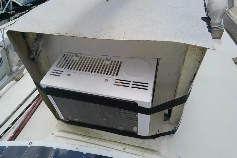 Slide: The Image of 1981 Sea Sprite 34 boat with a mounted air conditioning unit on deck. - 12