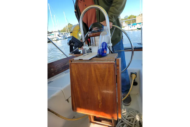 Slide: The Image of 1981 Sea Sprite 34 sailboat cockpit with steering wheel and wooden panel. - 14