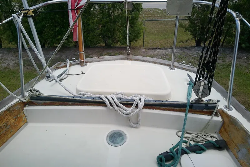 Slide: The Image of 1981 Sea Sprite 34 sailboat deck with ropes and railing, outdoor setting. - 16