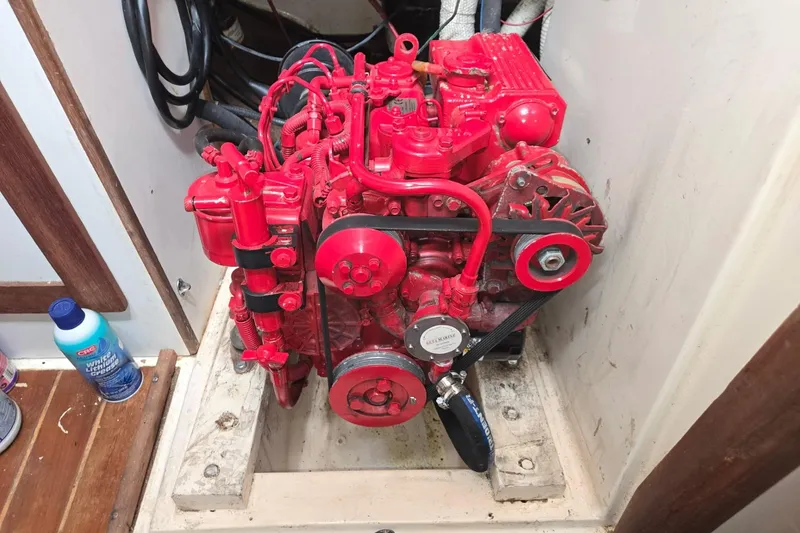 Slide: The Image of Red engine inside a 1981 Sea Sprite 34 sailboat, showcasing detailed mechanical components. - 18