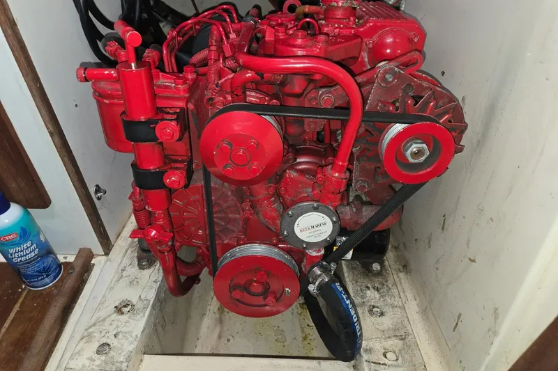 Slide: The Image of Red marine engine in a 1981 Sea Sprite 34 sailboat compartment. - 20