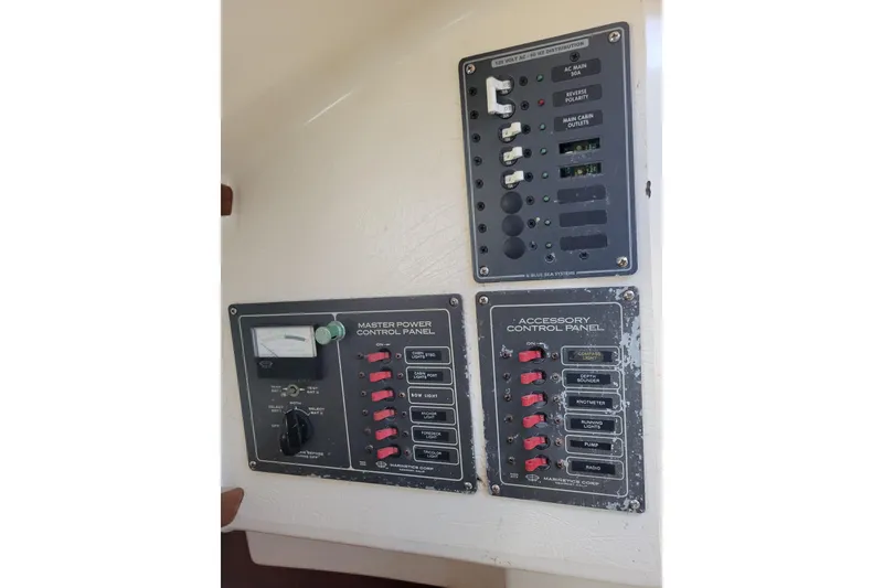 Slide: The Image of Electrical control panels on a 1981 Sea Sprite 34 boat, featuring switches and meters. - 21