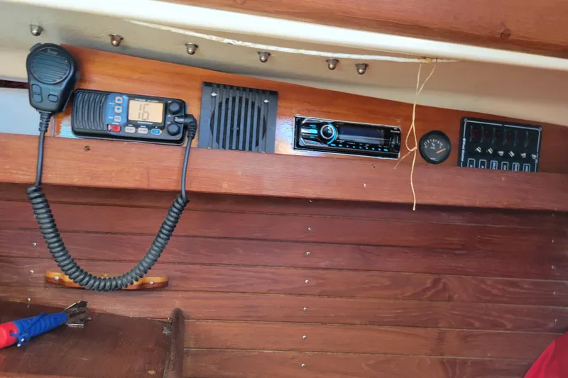 Slide: The Image of 1981 Sea Sprite 34 interior with radio equipment and wooden paneling. - 23