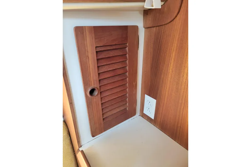 Slide: The Image of Wooden louvered cabinet door and electrical outlet in 1981 Sea Sprite 34 interior. - 30
