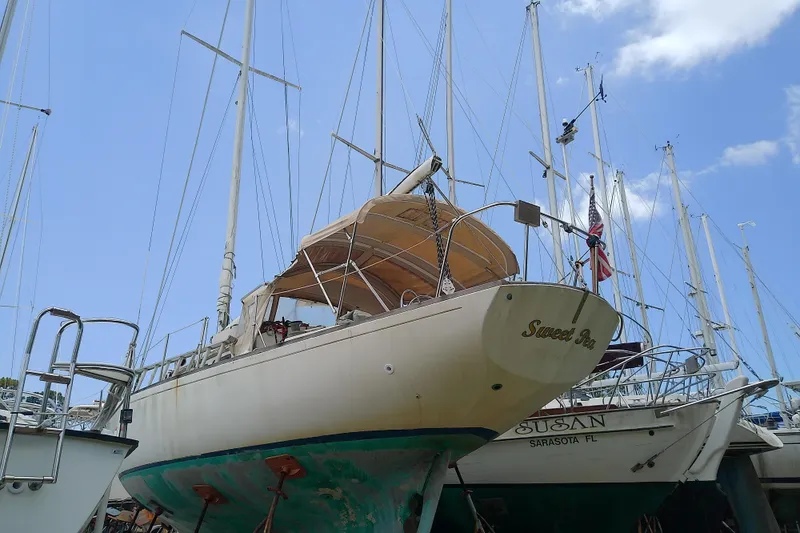 Slide: The Image of 1981 Sea Sprite 34 sailboat on dry dock, with clear blue sky background. - 4