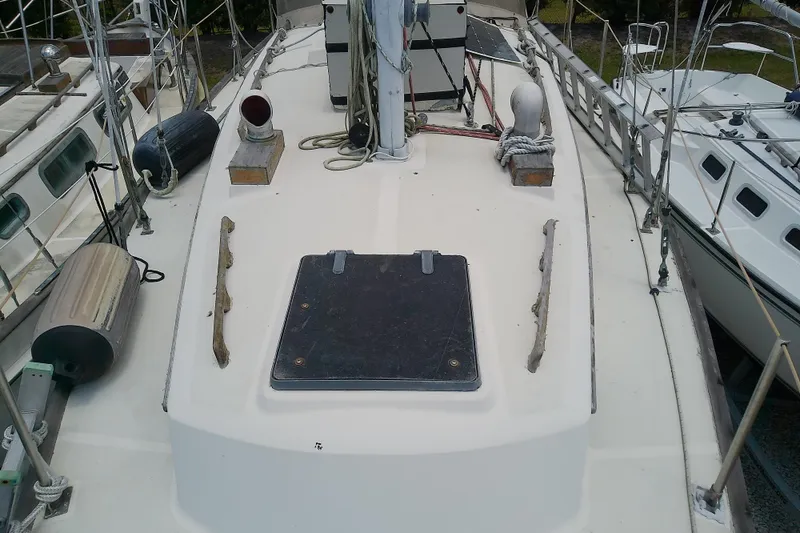 Slide: The Image of 1981 Sea Sprite 34 sailboat deck with hatch, ropes, and fenders. - 8
