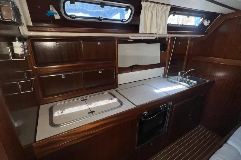 Slide: The Image of Interior of 2001 Bavaria 42 yacht kitchen with wooden cabinets and stainless steel sink. - 15