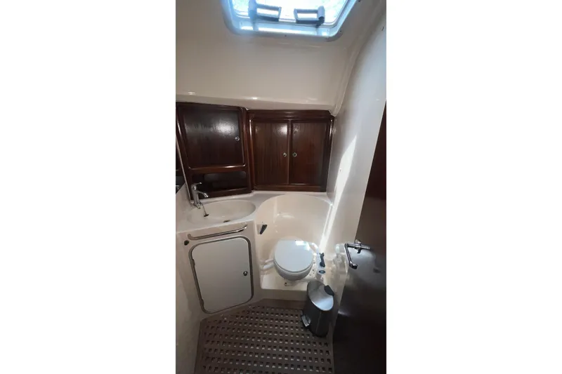 Slide: The Image of Bathroom interior of 2001 Bavaria 42 yacht with wooden cabinets and skylight. - 11