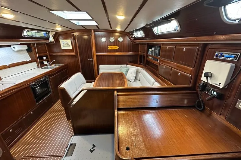 Slide: The Image of Luxurious interior of a 2001 Bavaria 42 yacht with wood finish and cozy seating area. - 5