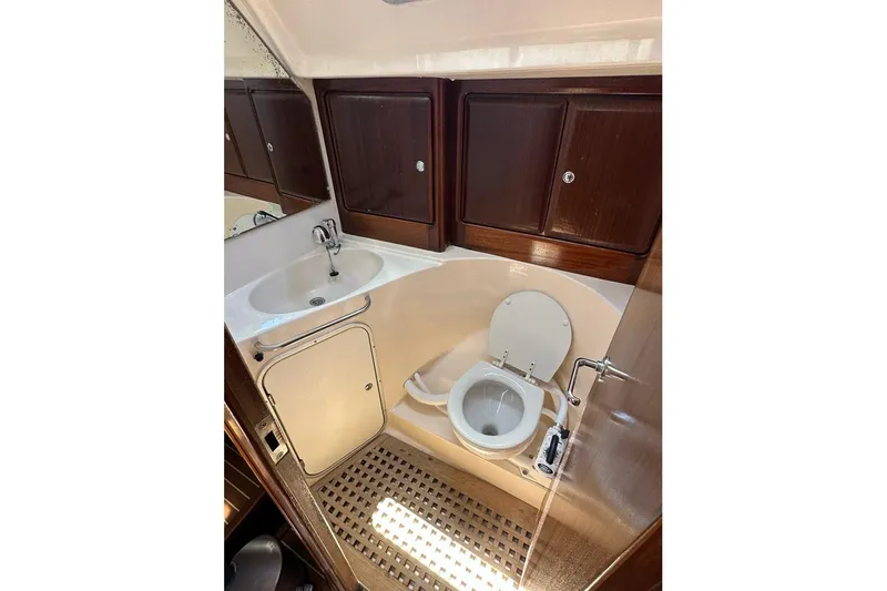 Slide: The Image of Interior of 2001 Bavaria 42 yacht bathroom with sink, toilet, and wooden cabinets. - 6
