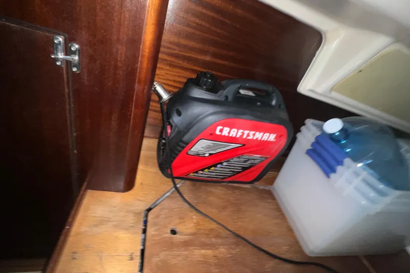 Slide: The Image of Craftsman tool and water container inside a 2001 Bavaria 42 yacht cabin. - 8