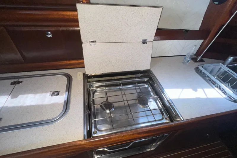 Slide: The Image of Compact kitchen area in a 2001 Bavaria 42 yacht with a two-burner stove. - 10