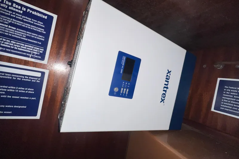 Slide: The Image of Xantrex inverter installed on Bavaria 42 yacht, 2001 model, with safety notices. - 14