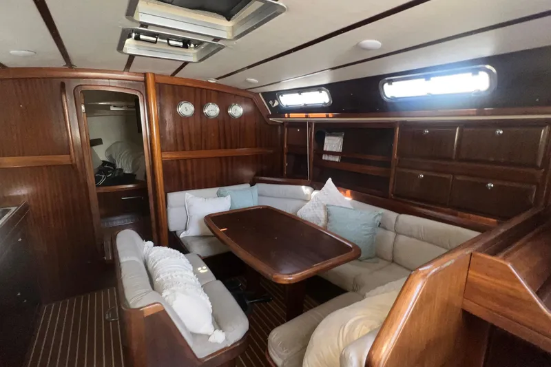Slide: The Image of Luxurious interior of a 2001 Bavaria 42 yacht with wooden furnishings and cozy seating. - 17