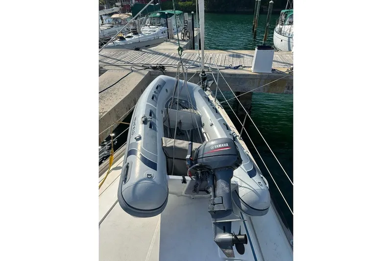 Slide: The Image of Inflatable dinghy with Yamaha motor on Bavaria 42 sailboat, docked at marina. - 3