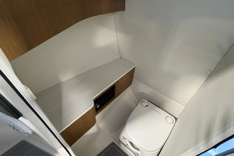 Slide: The Image of Compact bathroom in 2027 Regal LS6 with modern fixtures and wooden accents. - 14