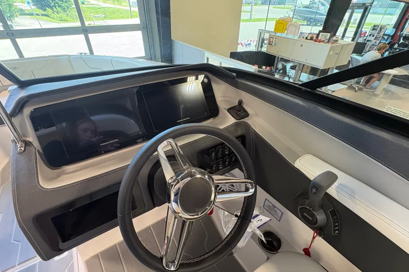 Slide: The Image of 2027 Regal LS6 boat dashboard with modern steering wheel and dual display screens. - 12