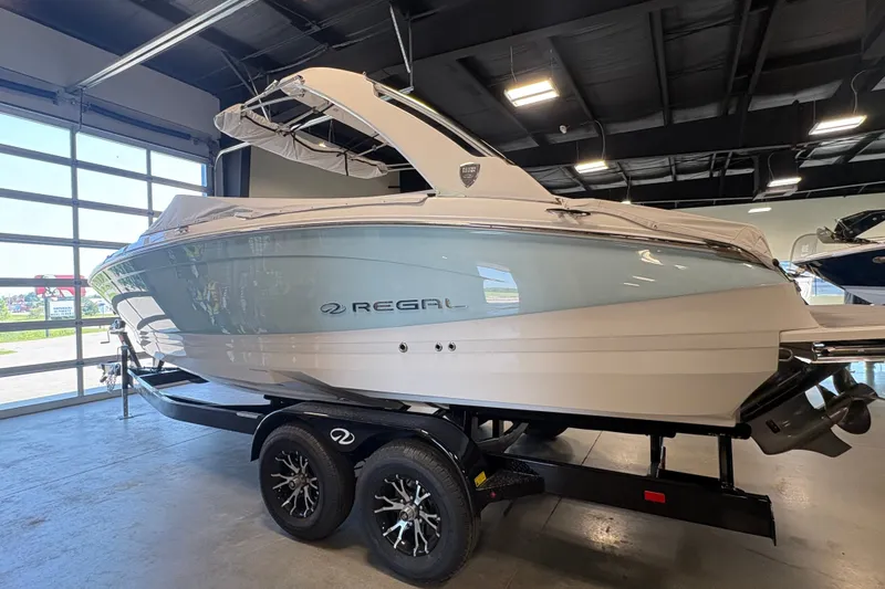 Slide: The Image of 2027 Regal LS6 boat on trailer in showroom, sleek design, modern features. - 1
