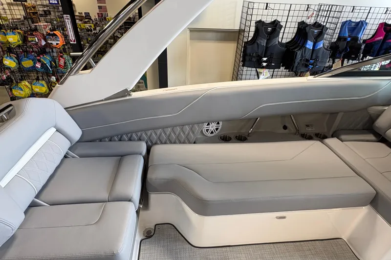 Slide: The Image of Interior of 2027 Regal LS6 boat with gray seating and life jackets displayed. - 18