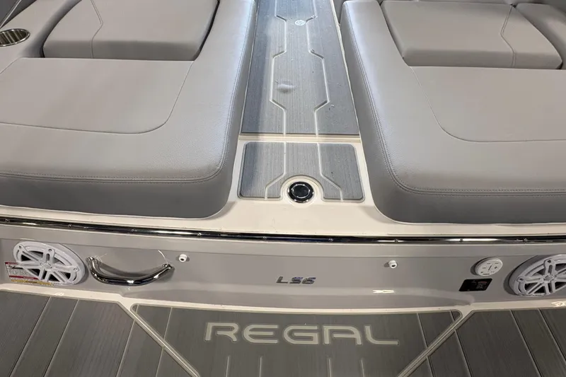 Slide: The Image of 2027 Regal LS6 boat interior with gray seating and sleek design elements. - 23