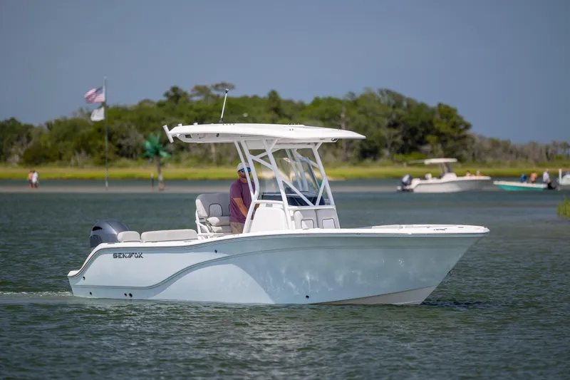 The Image of 2022 Sea Fox 228 Commander boat cruising on a sunny day near a shoreline. - 0