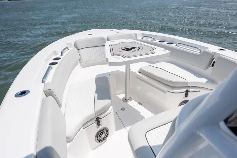 Slide: The Image of 2022 Sea Fox 228 Commander boat interior with seating and table on the water. - 10
