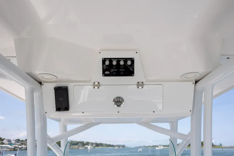 Slide: The Image of 2022 Sea Fox 228 Commander boat console with controls and storage compartment. - 21