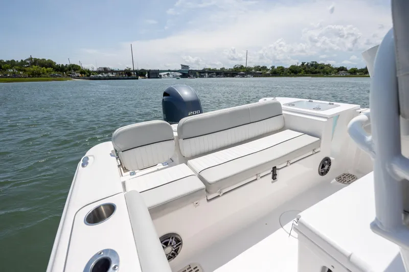 Slide: The Image of 2022 Sea Fox 228 Commander boat interior with seating, on calm water. - 22