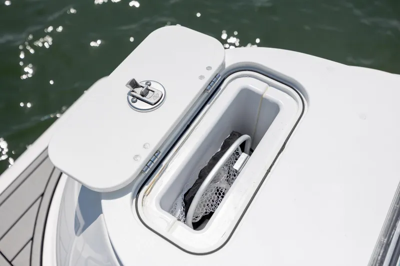 Slide: The Image of 2022 Sea Fox 228 Commander boat storage compartment with open lid on water. - 26