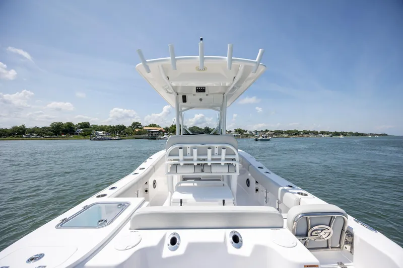 Slide: The Image of 2022 Sea Fox 228 Commander boat on calm water, featuring spacious deck and seating. - 29