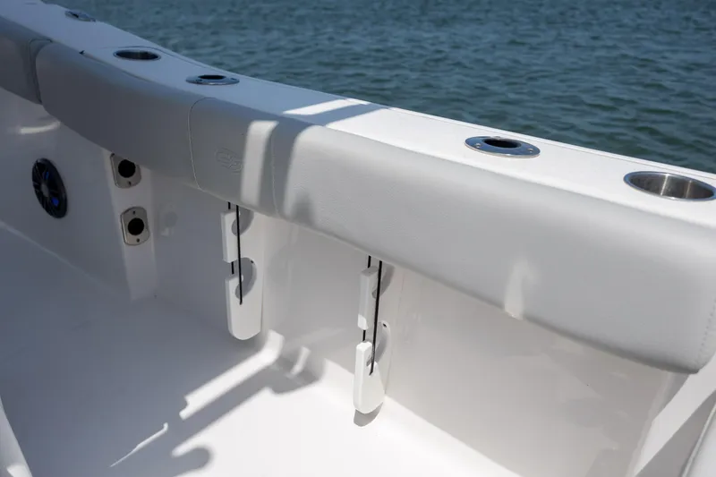 Slide: The Image of 2022 Sea Fox 228 Commander boat interior with rod holders and cup holders by the water. - 31