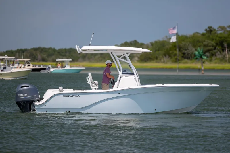 Slide: The Image of 2022 Sea Fox 228 Commander boat cruising on a calm waterway. - 8
