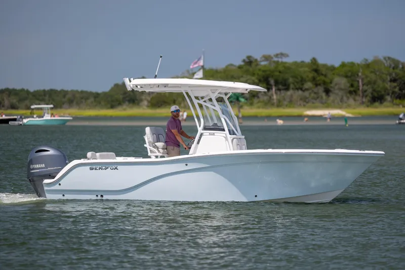 Slide: The Image of 2022 Sea Fox 228 Commander boat cruising on a calm lake with a Yamaha engine. - 9