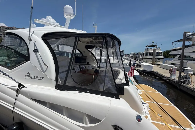 Slide: The Image of 2007 Sea Ray 44 Sundancer yacht docked at marina under clear blue sky. - 10