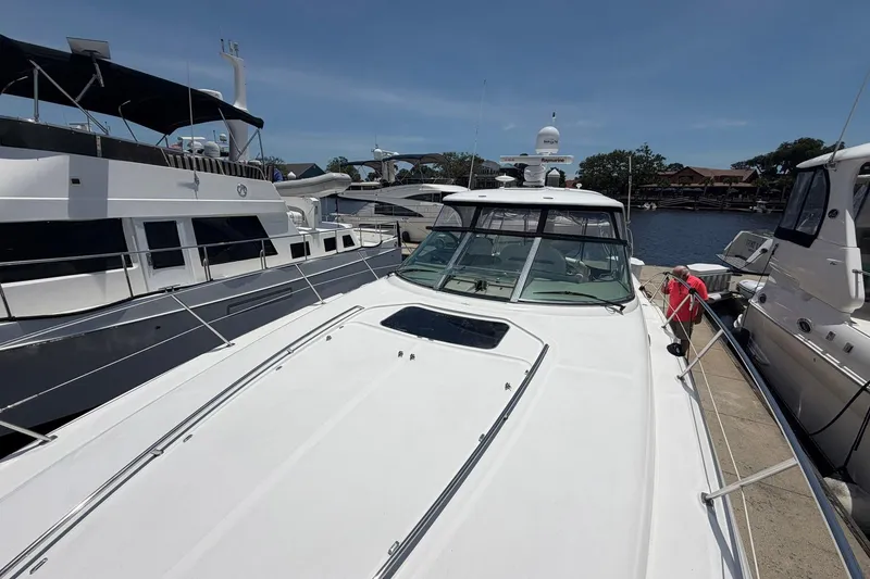 Slide: The Image of 2007 Sea Ray 44 Sundancer yacht docked at marina under clear blue sky. - 12