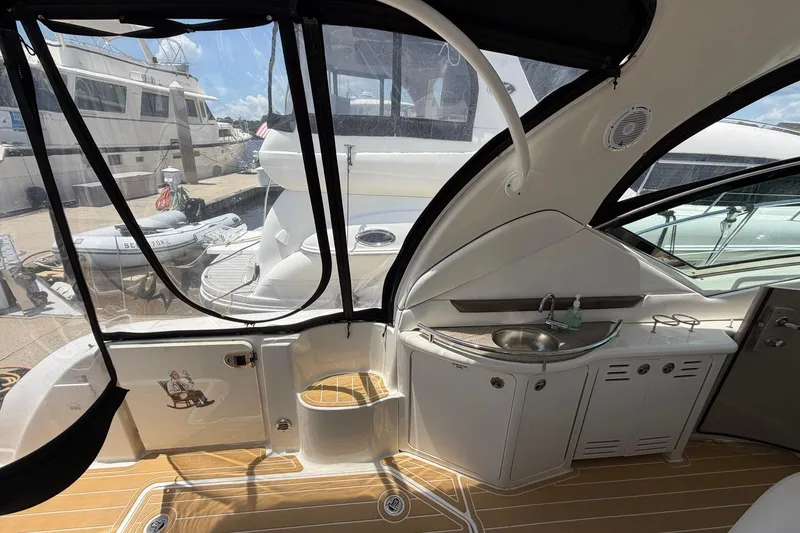 Slide: The Image of 2007 Sea Ray 44 Sundancer yacht interior with kitchenette and seating area. - 16