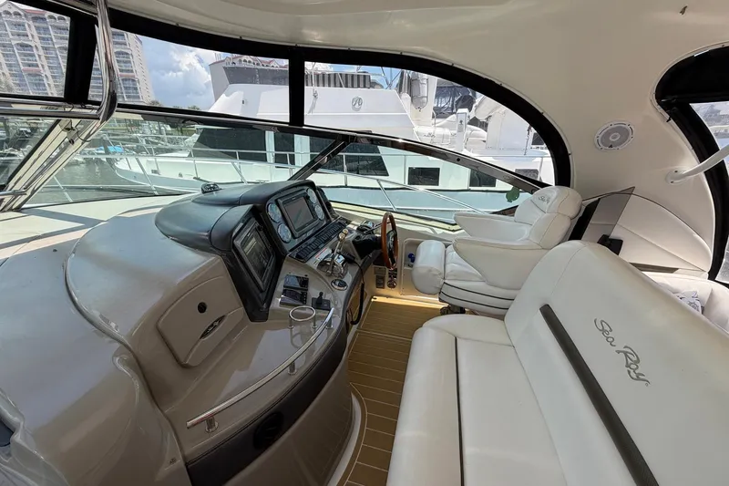Slide: The Image of Luxurious 2007 Sea Ray 44 Sundancer yacht interior with helm and seating area. - 20