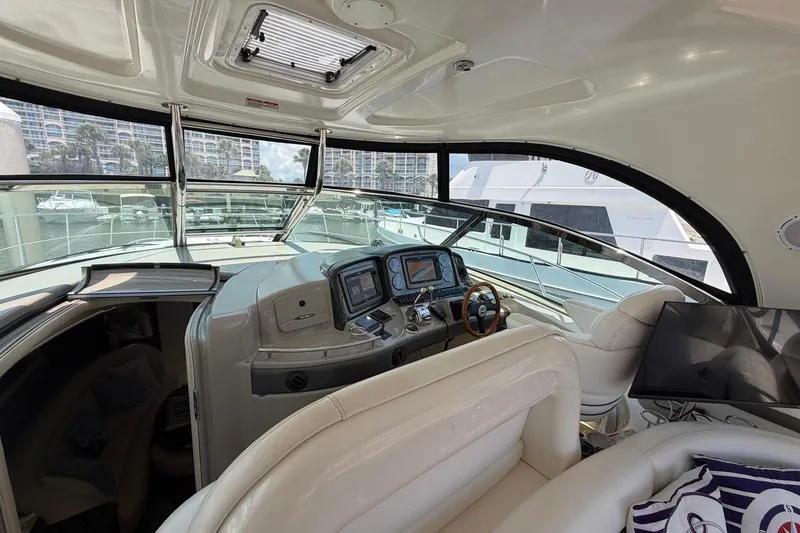 Slide: The Image of Luxurious 2007 Sea Ray 44 Sundancer yacht interior with modern helm and plush seating. - 23