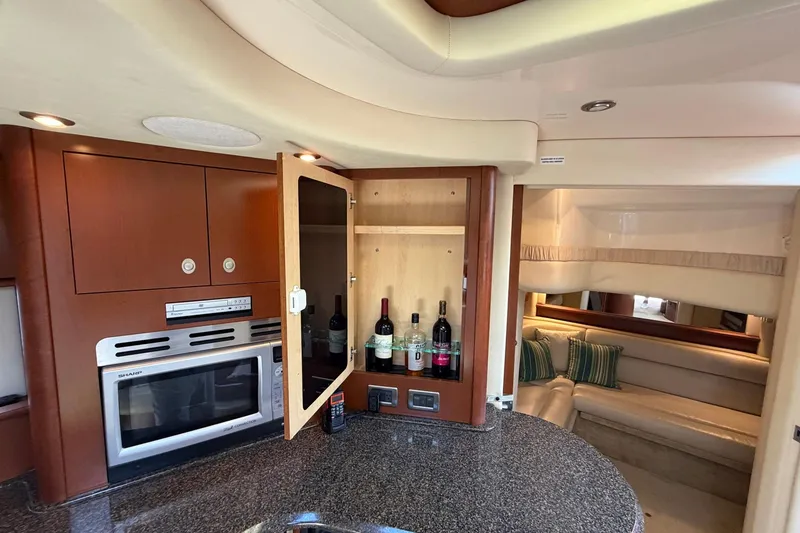 Slide: The Image of Luxurious 2007 Sea Ray 44 Sundancer yacht interior with kitchenette and cozy seating area. - 29